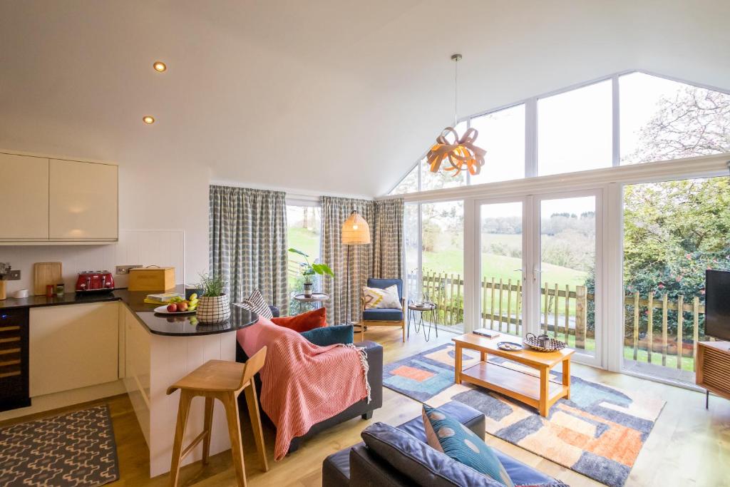 a kitchen and living room with a large window at Bosinver Farm Cottages Well Close in St Austell