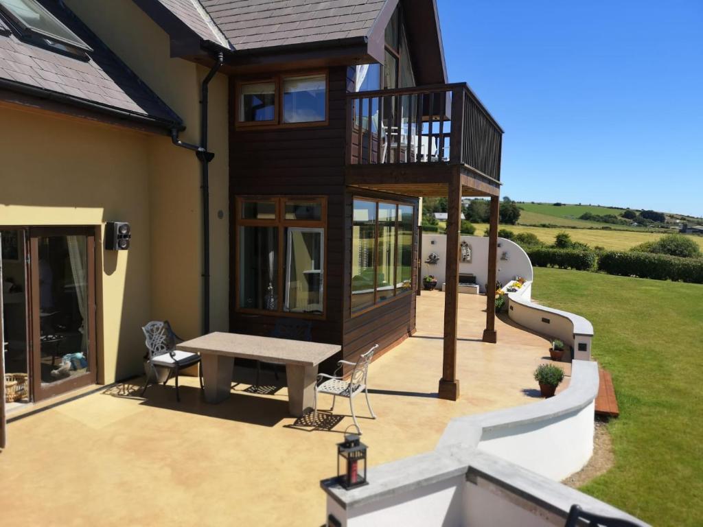 a house with a playground with a slide at Ocean view in Castlemartyr