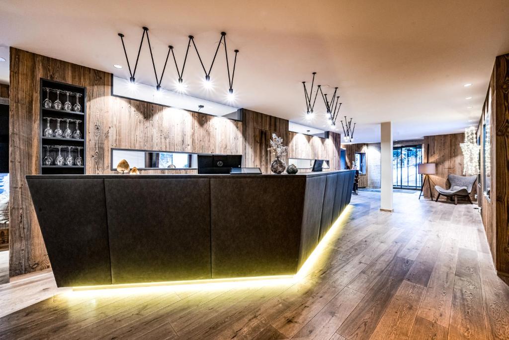 a kitchen with a dark green counter and wooden walls at Hotel Alpina Sölden - Adults Only in Sölden