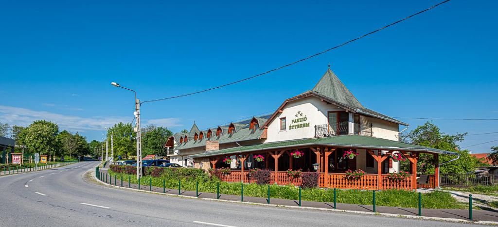 a building on the side of a road at Gasthaus Panzió in Szilvásvárad