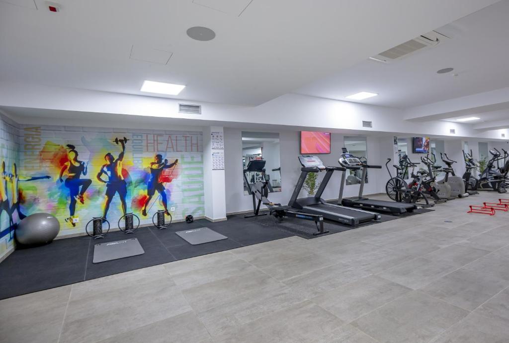 a gym with bikes and exercise equipment in a room at Hotel Rural Brícia Du Mar in Ferragudo