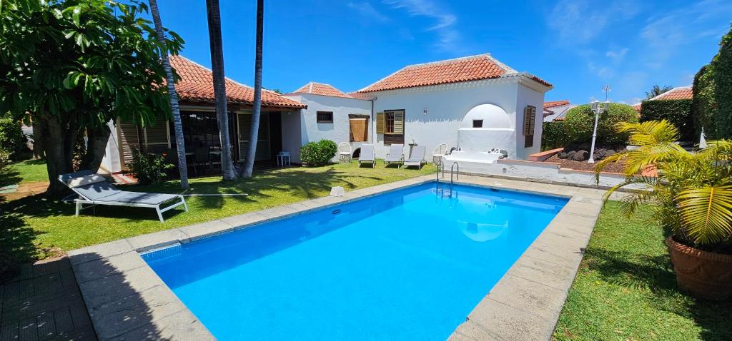 a swimming pool in front of a house at Villa la Paz in Puerto de la Cruz