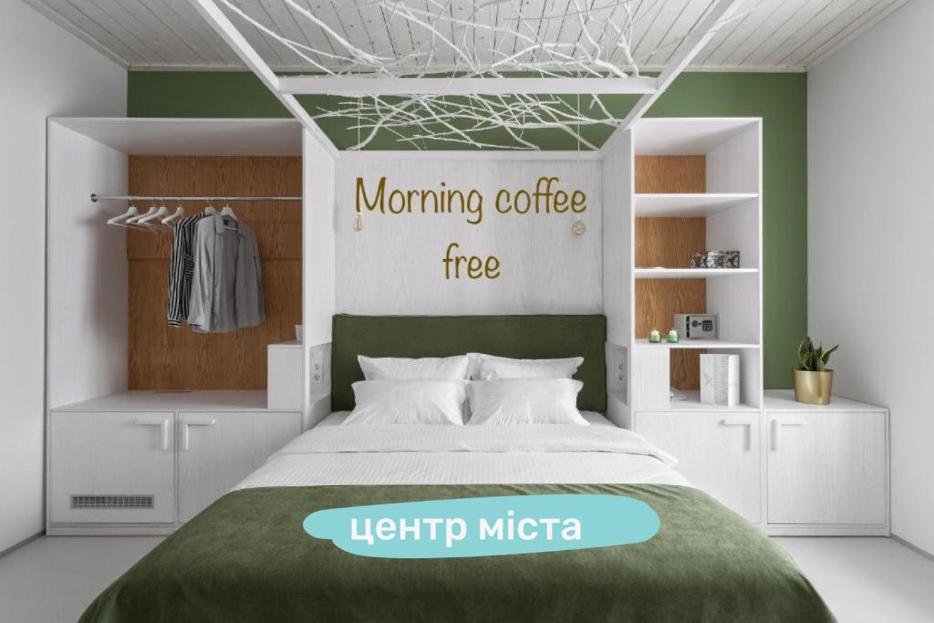 a bedroom with a bed and a light up mica sign at City Hotel Bortoli by Ribas in Odesa