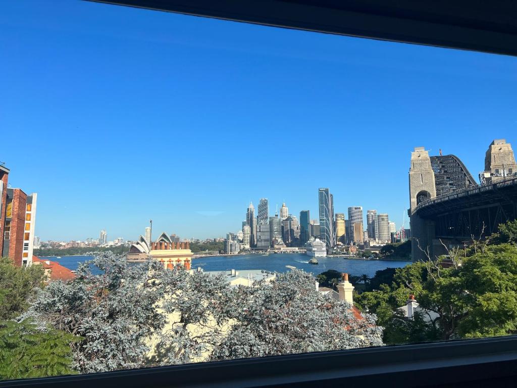 a view of the sydney city skyline from a window at The Kirribilli in Sydney