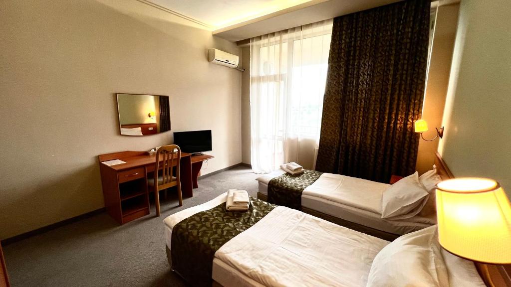 Postel nebo postele na pokoji v ubytování Olympia Garden Hotel