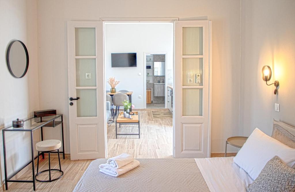 a bedroom with a bed and a living room at Happiness Aegina Apartments in Aegina Town