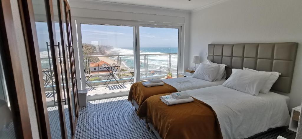 Cama ou camas em um quarto em Mega Ocean Magoito - Sintra