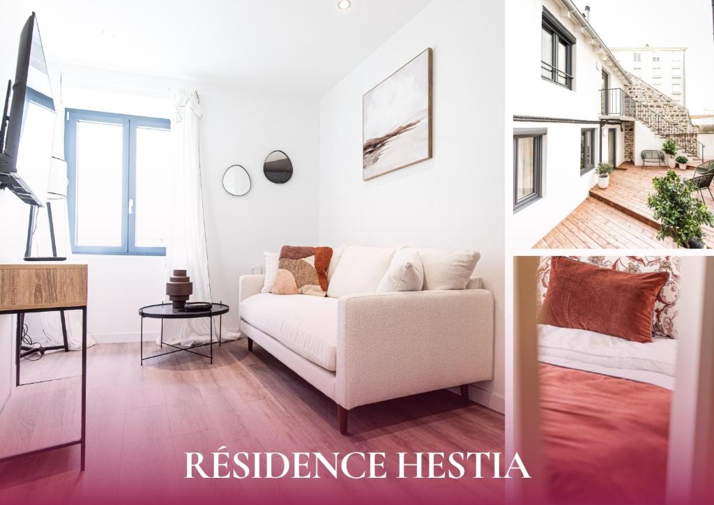 een woonkamer met een witte bank en een tafel bij Bliss - Résidence Hestia in Saint-Étienne