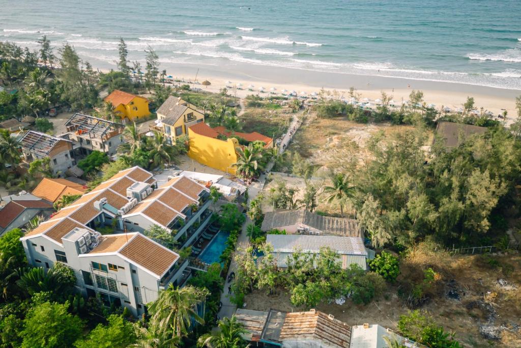 an aerial view of a house and the beach at CHiEM HoiAn - The Beachside Boutique Hotel & Villa in Hoi An