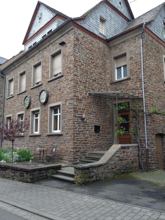 a brick building with two clocks on the side of it at Ferienhaus Casa Alfredo in Pommern