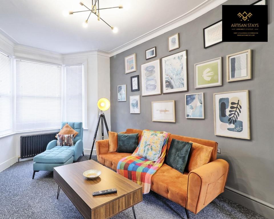 a living room with a couch and a table at Vintage Vibes By Artisan Stays in Southend-On-Sea I Free Parking I Weekly Or Monthly Stay Offer in Southend-on-Sea