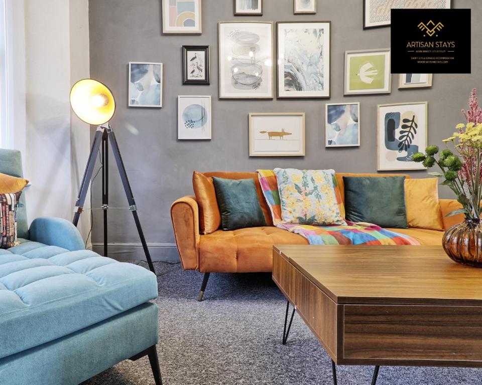 a living room with a couch and a table at Vintage Vibes By Artisan Stays in Southend-On-Sea I Free Parking I Weekly & Monthly Stay Offer in Southend-on-Sea