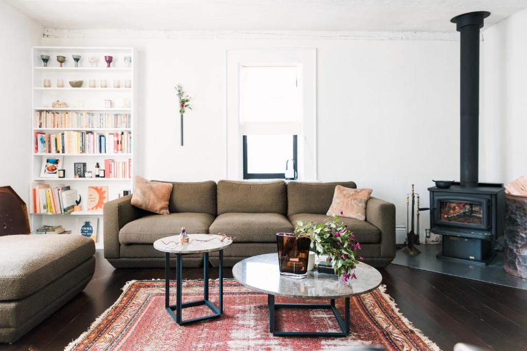 a living room with a couch and a coffee table at Hart House a fresh 3 bedroom century home in Cherry Valley