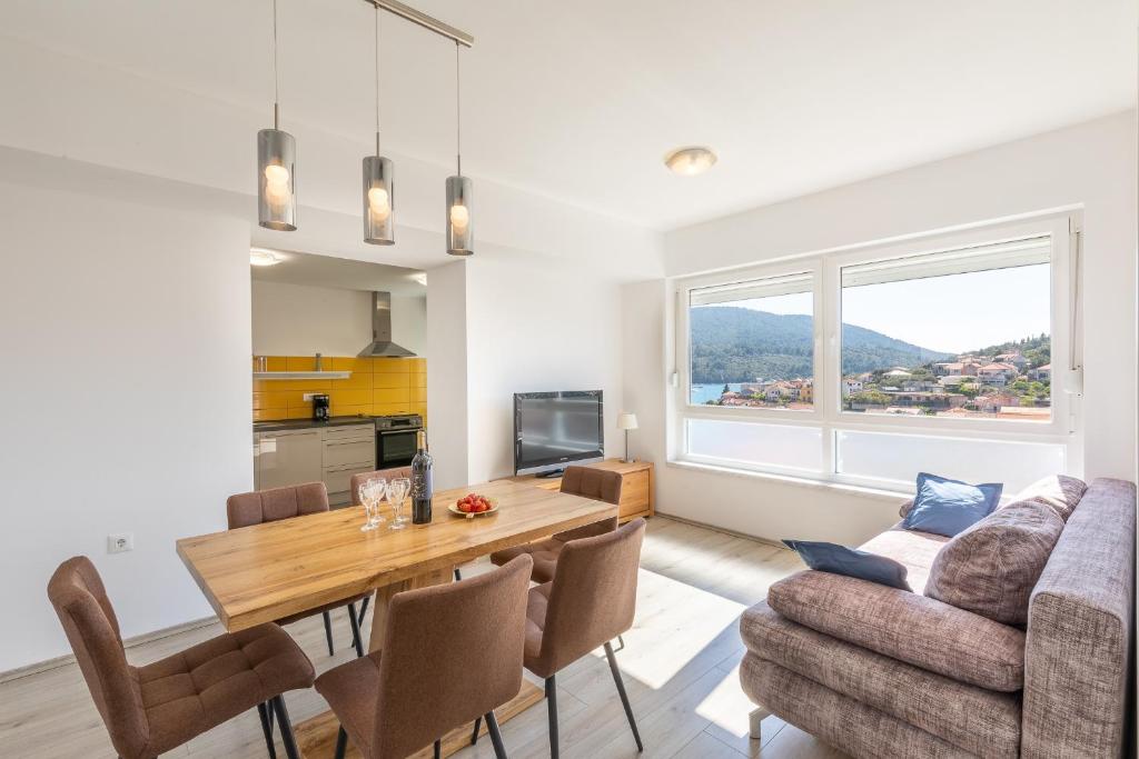 a living room with a table and a couch at Seaview Vela Luka in Vela Luka