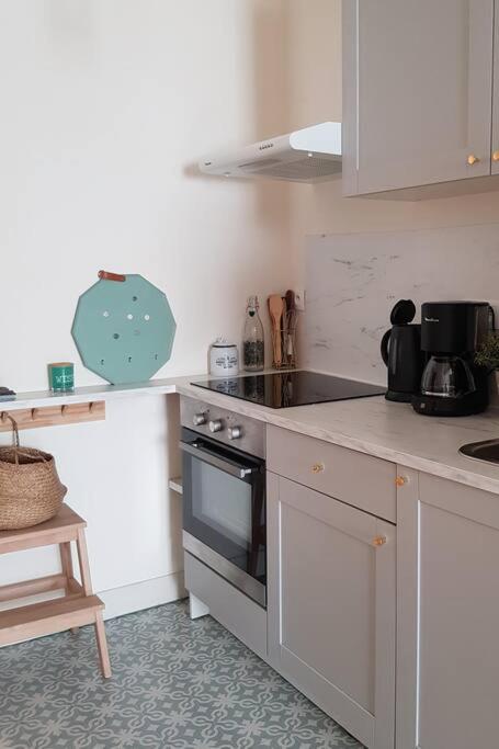 a kitchen with a stove and a counter top at Bel appartement, 2 chambres, centre ville in Thiers