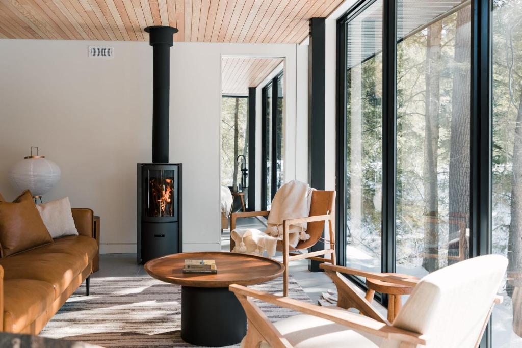 a living room with a couch and a fireplace at nortehaus - Nordic and Japanese inspired escape in Norland