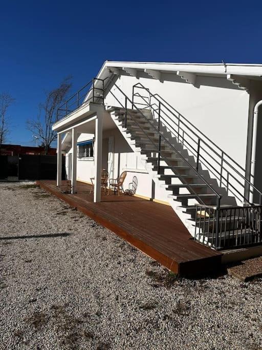 a large deck with a staircase on a house at Maison de vacances Bisca in Biscarrosse