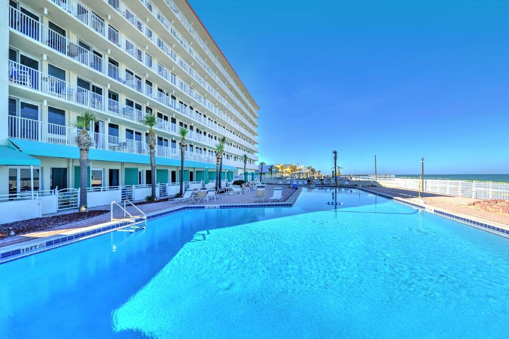 a large swimming pool in front of a building at Harbour Beach Resort in Daytona Beach