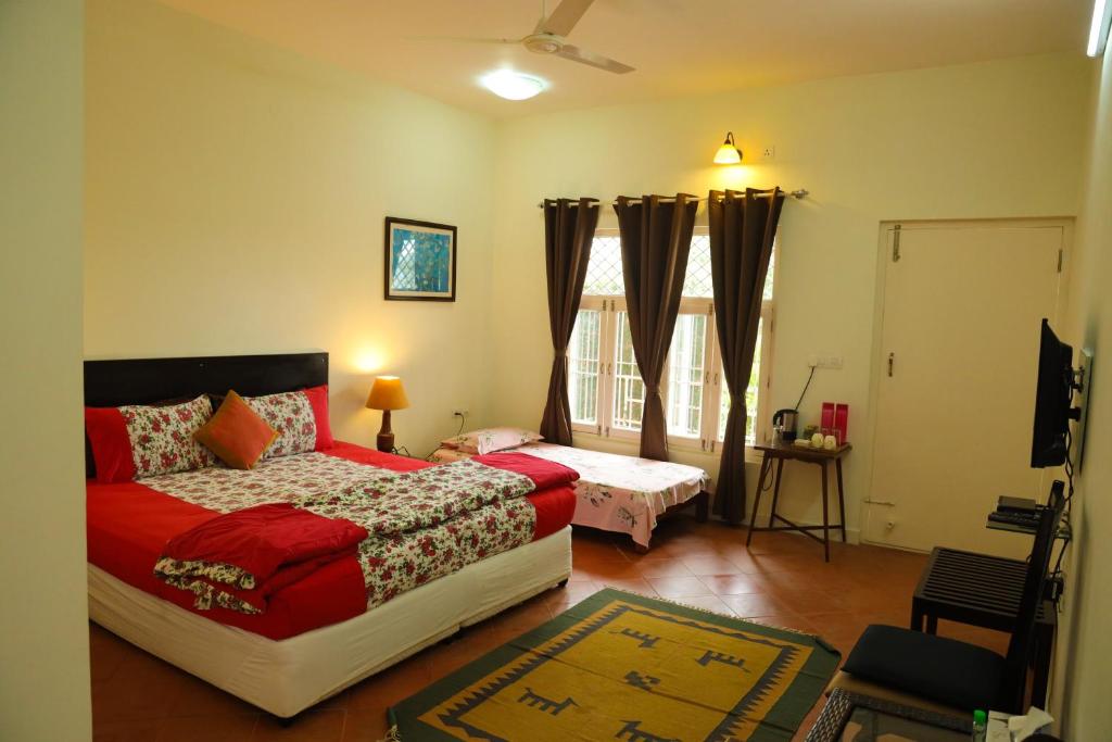 a bedroom with a bed and a window at Copperhill- A Luxury Homestay in Madikeri