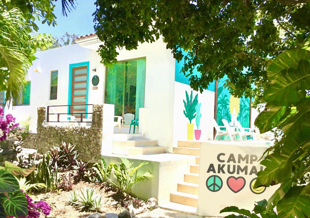 uma casa com um sinal em frente em CAMP AKUMAL - Hosted Family Bungalows em Akumal