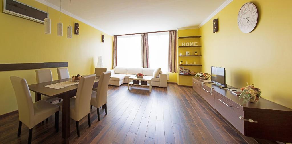 a living room with a table and a dining room at Golden apartman in Gyula