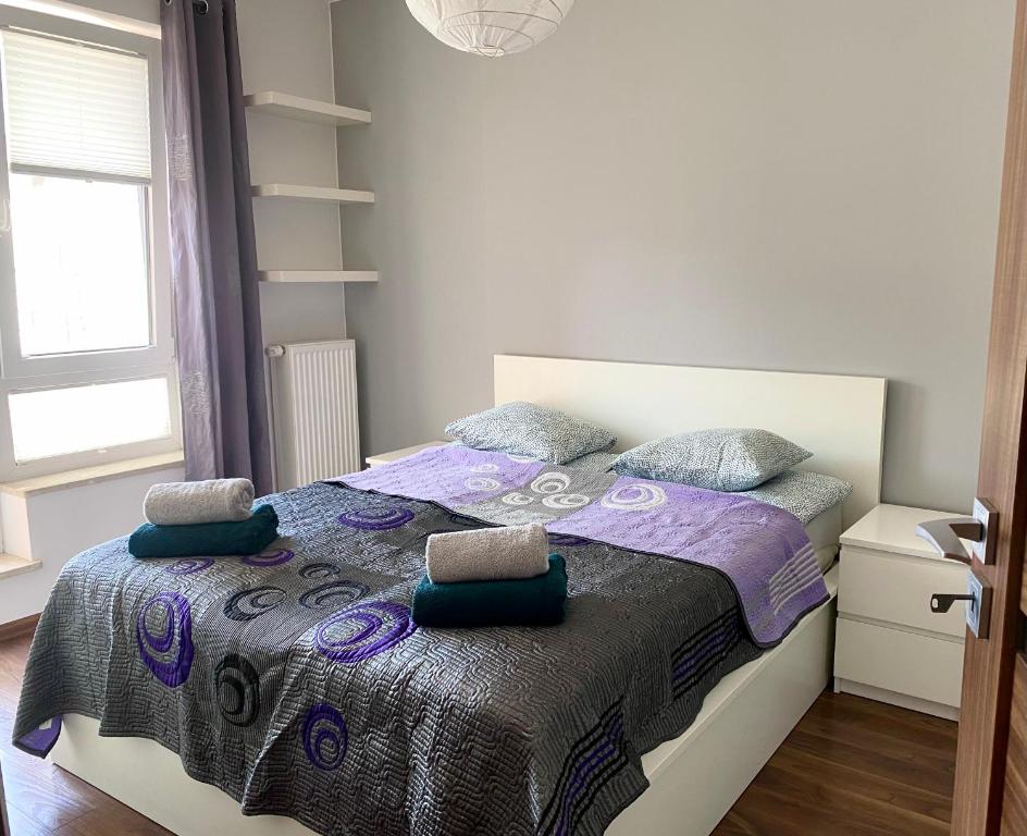 1 dormitorio con 1 cama con manta morada en Project Comfort Apartament Jana Kazimierza 17/47 Wola, en Varsovia