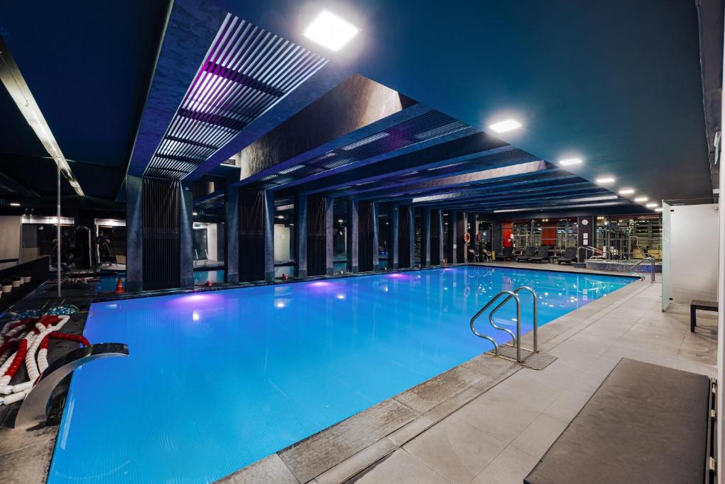 a large swimming pool in a building at Bliss Residence & Spa in Budapest