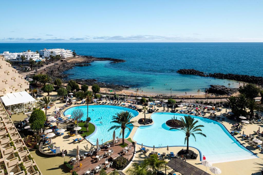an aerial view of a resort with a swimming pool at Grand Teguise Playa in Costa Teguise