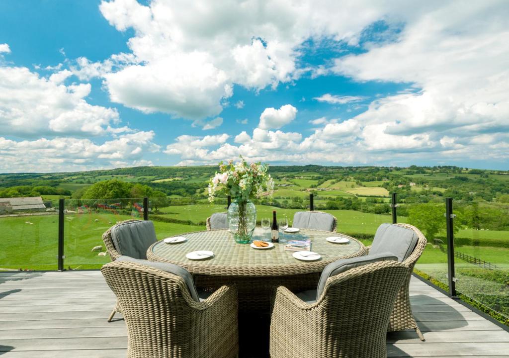 a table and chairs on a patio with a view at The Piggery in Sleights