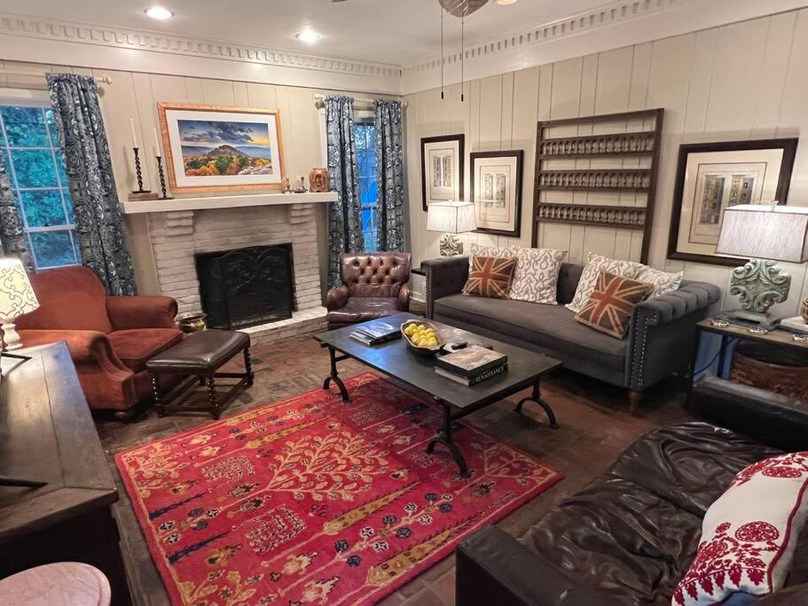 a living room with a couch and a fireplace at Elegant 6 Bedroom Home in Heart of Memphis in Memphis
