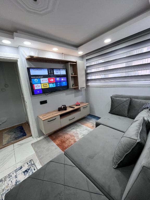 a living room with a couch and a flat screen tv at LİFE APART- basement in Istanbul