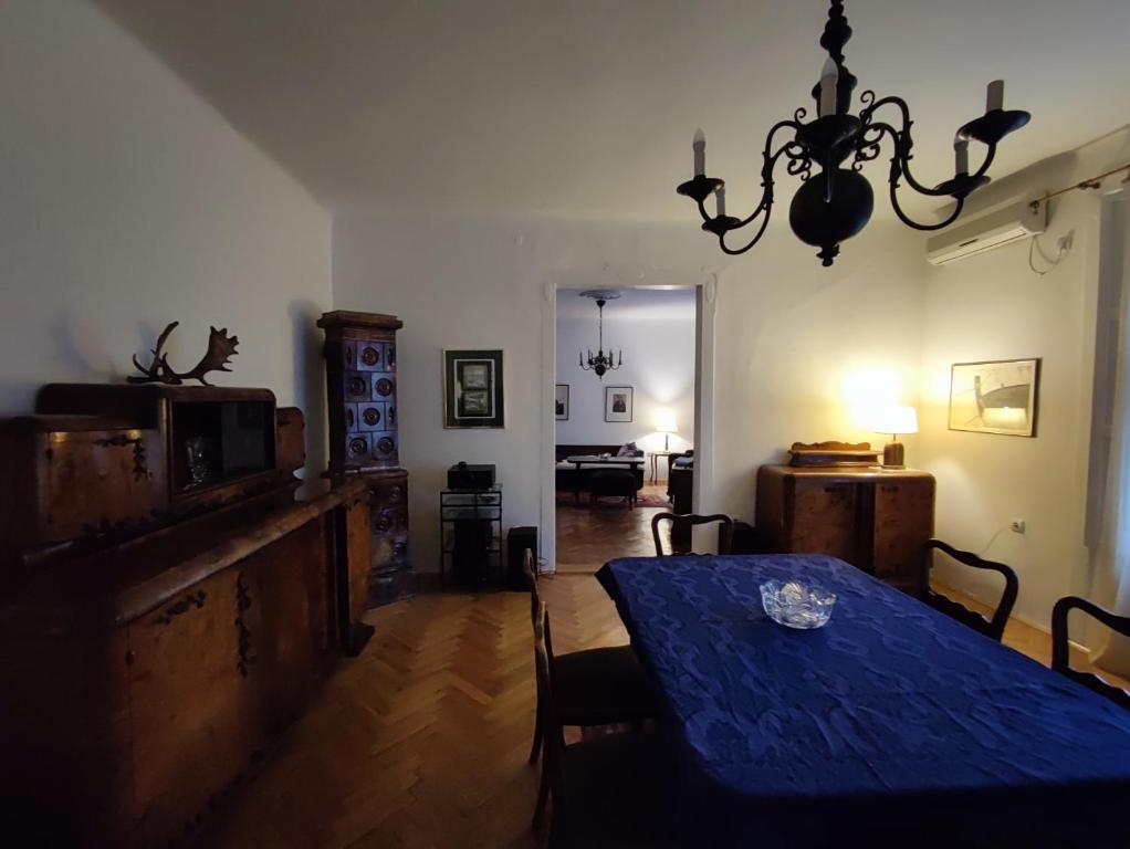 a dining room with a blue table in a room at Vintage apartment in the center of Novi Sad in Novi Sad