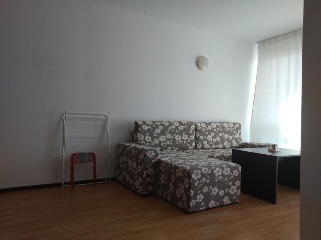 a living room with a couch and a table at Апартамент Тита in Burgas