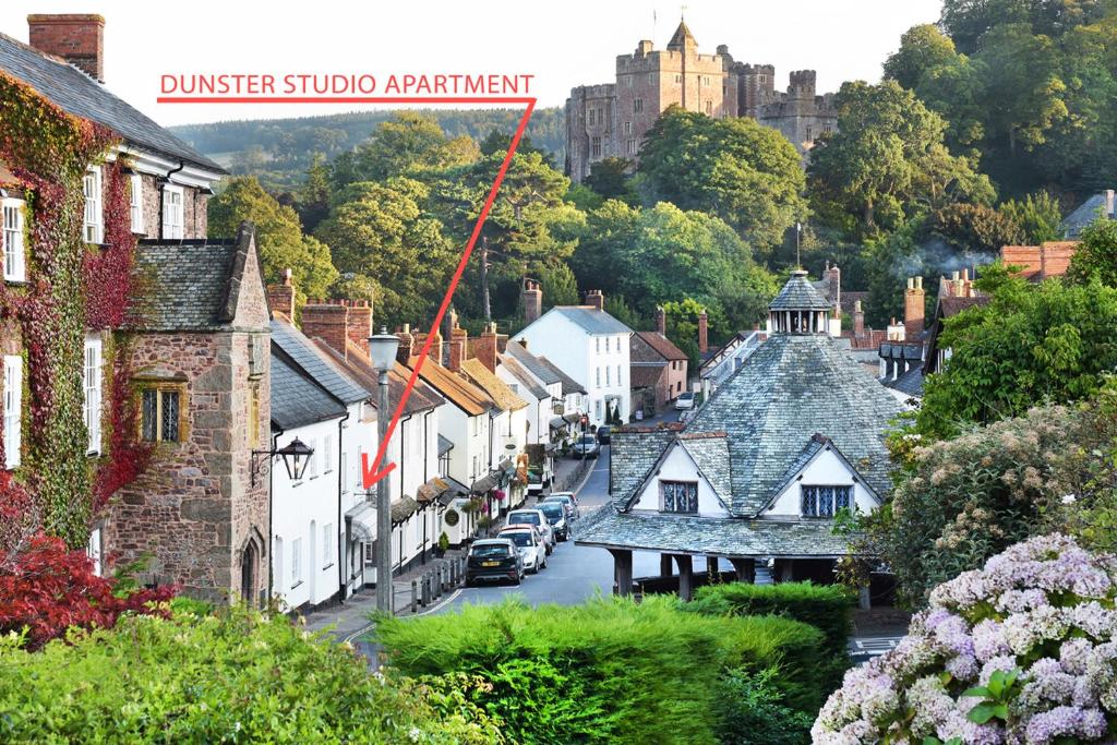 a view of a town with a castle in the background at Dunster Studio Apartment in Dunster