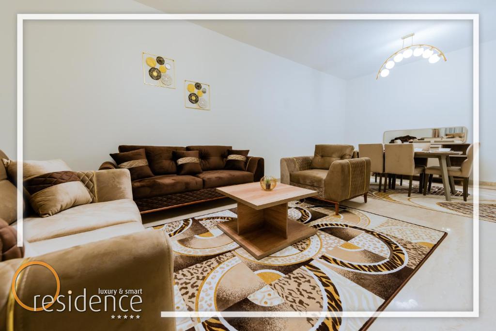 a living room with couches and a table at Luxury apartments in Mivida new cairo in New cairo