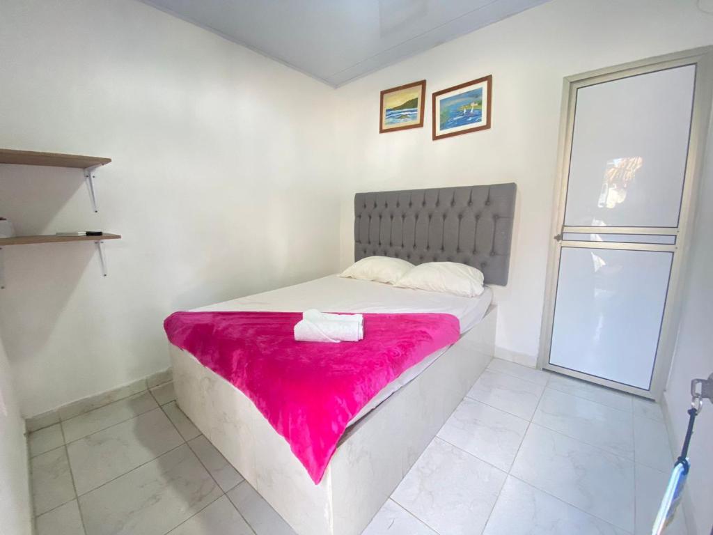 Postel nebo postele na pokoji v ubytování Hostal El Danubio Tolu