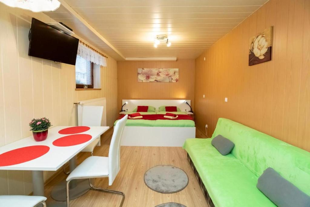 1 dormitorio con cama, mesa y sofá en Studio Ara, en Bohinj