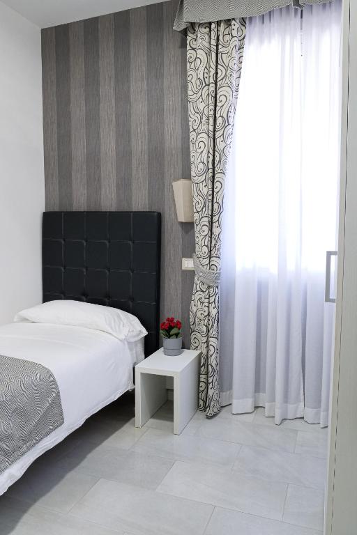 Postel nebo postele na pokoji v ubytování Hotel Terrazza Magenta