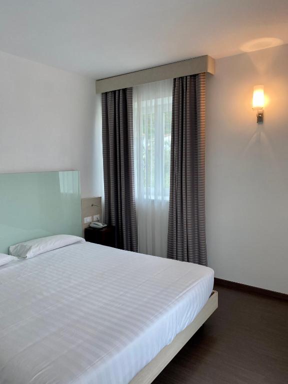 Postel nebo postele na pokoji v ubytování Hotel Campagnola