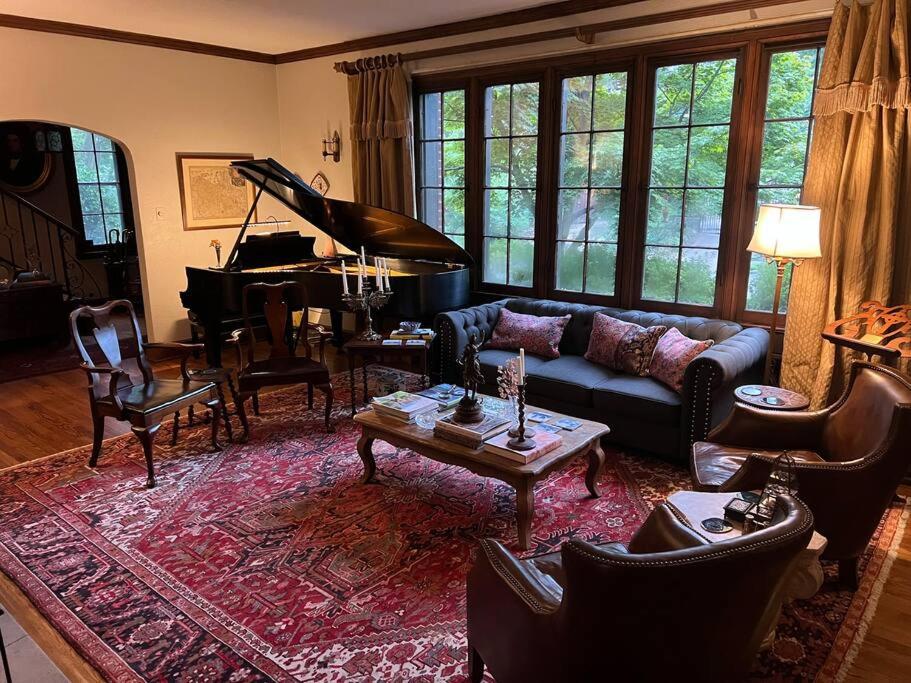 a living room with a couch and a piano at Luxury and Old World Charm in Historic Midtown in Memphis