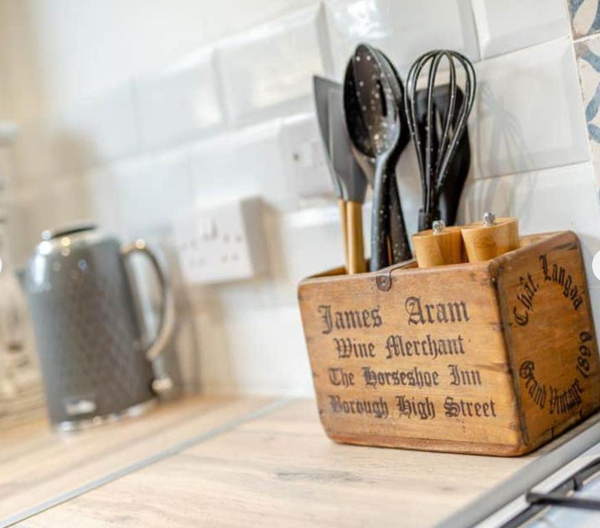 a wooden block of utensils sitting on a counter at Newly renovated Stables conversion in Burstwick