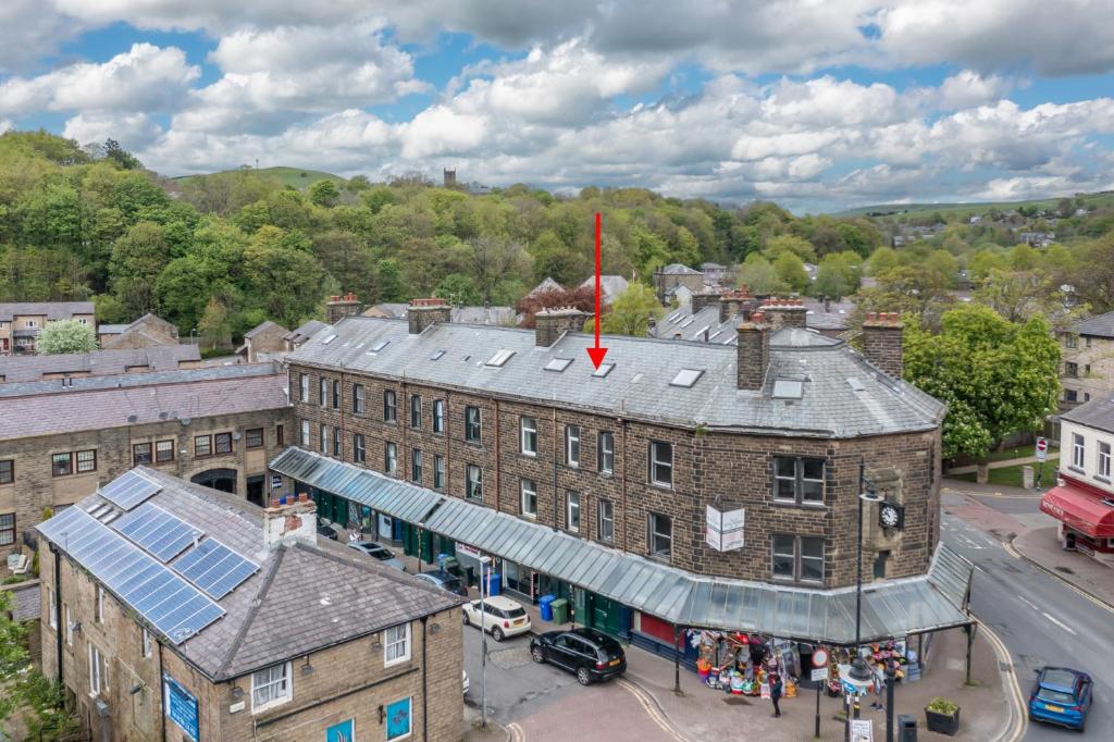 an overhead view of a building with a red flag on the roof at Victoria Parade in Rossendale