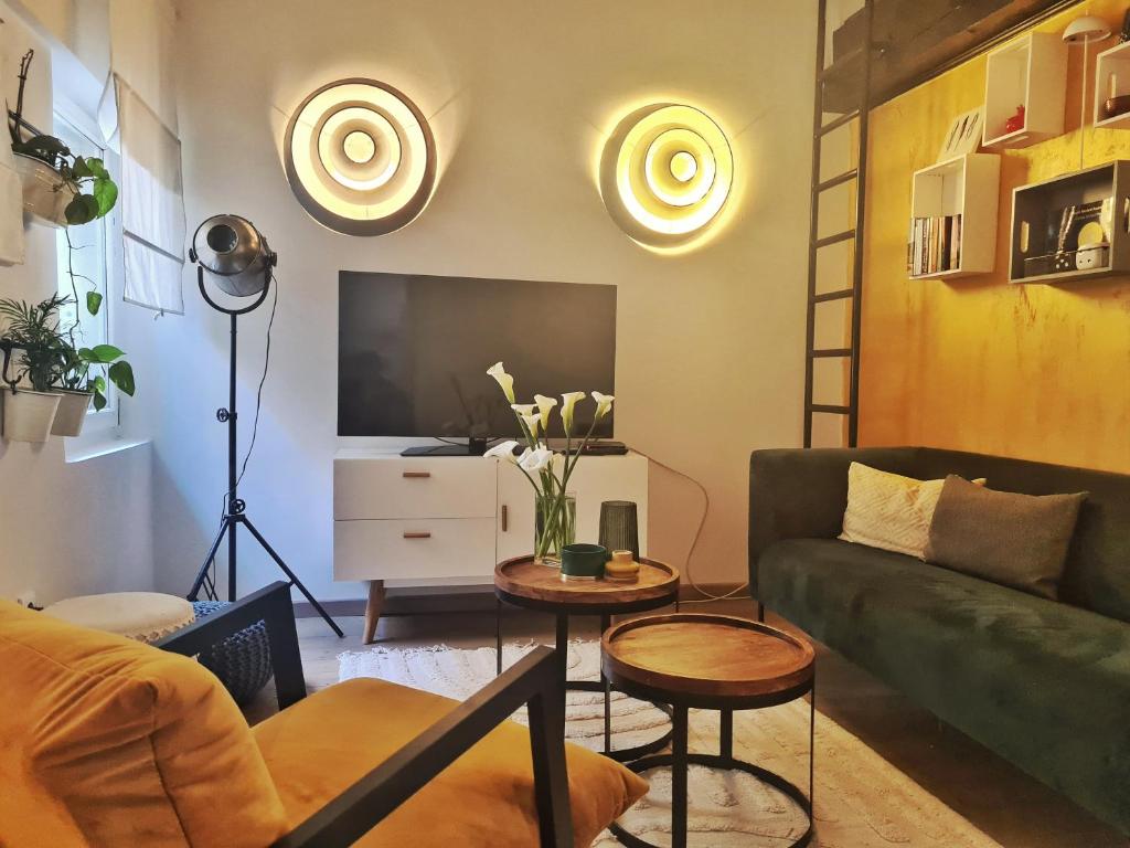 Televízia a/alebo spoločenská miestnosť v ubytovaní Grisia 26 Apartment