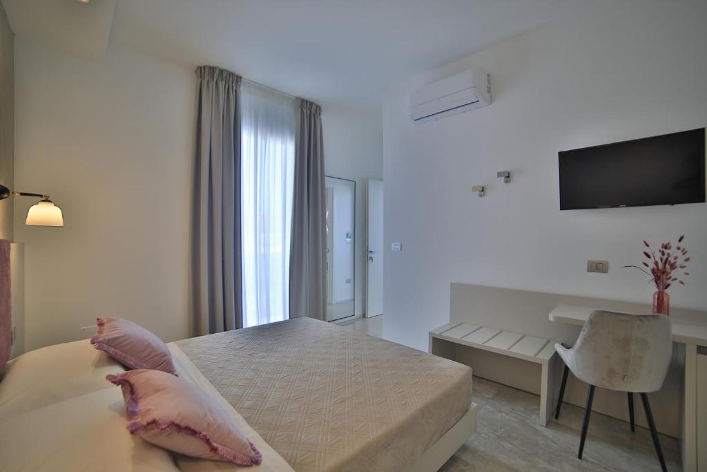 Posteľ alebo postele v izbe v ubytovaní Calaluna Rooms