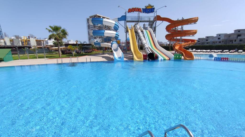 a large pool with a water slide on a cruise ship at Edelweiss Resort Luxury Studio Apartment in Iskele