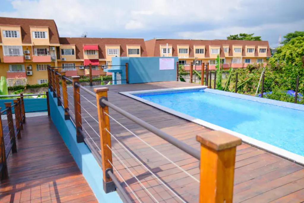 a deck with a swimming pool on top of a building at Choose To Be Happy at Brompton Estates - One and Two Bedroom with Pool in Kingston