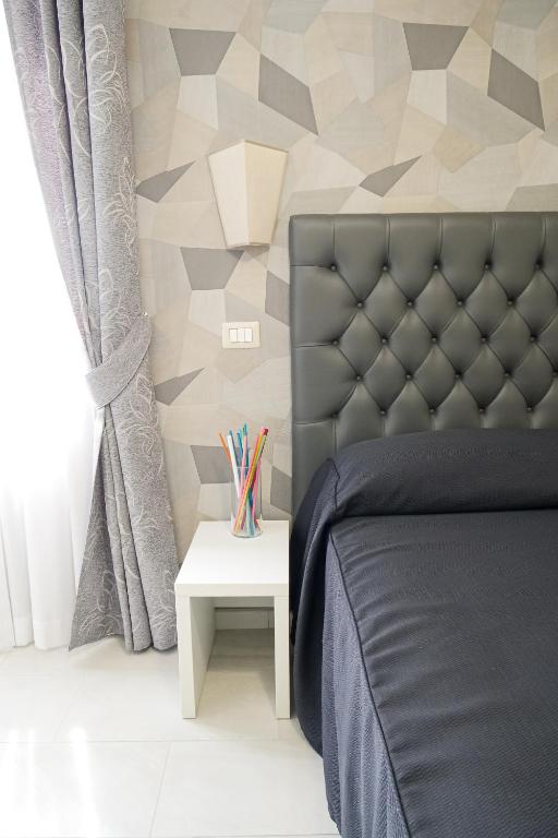 Postel nebo postele na pokoji v ubytování Hotel Terrazza Magenta