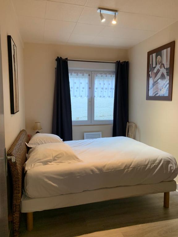 une chambre avec un grand lit avec une fenêtre dans l'établissement Chez François, à Boulogne-sur-Mer