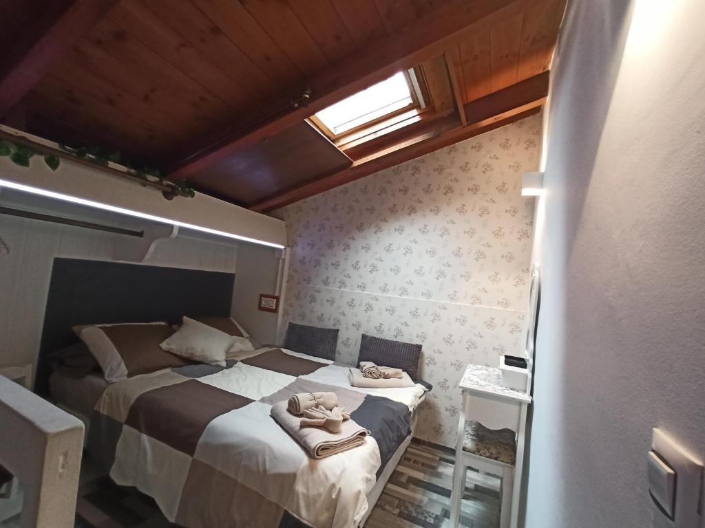 a bedroom with a bed with towels on it at La Casita in Gijón
