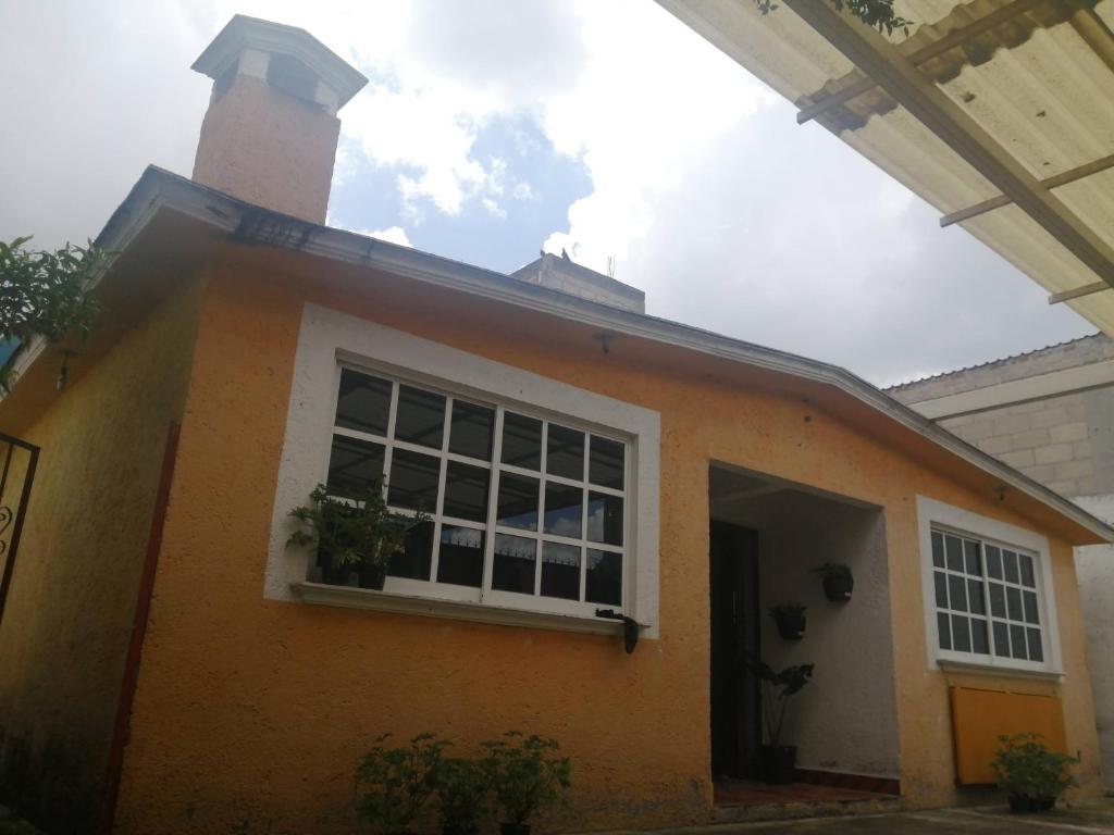 トルーカにあるAmpliaCasaconPrivacidadの小さなオレンジの家(煙突、窓付)